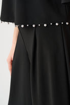 Silky Knit Flared Top With Pearl Detail